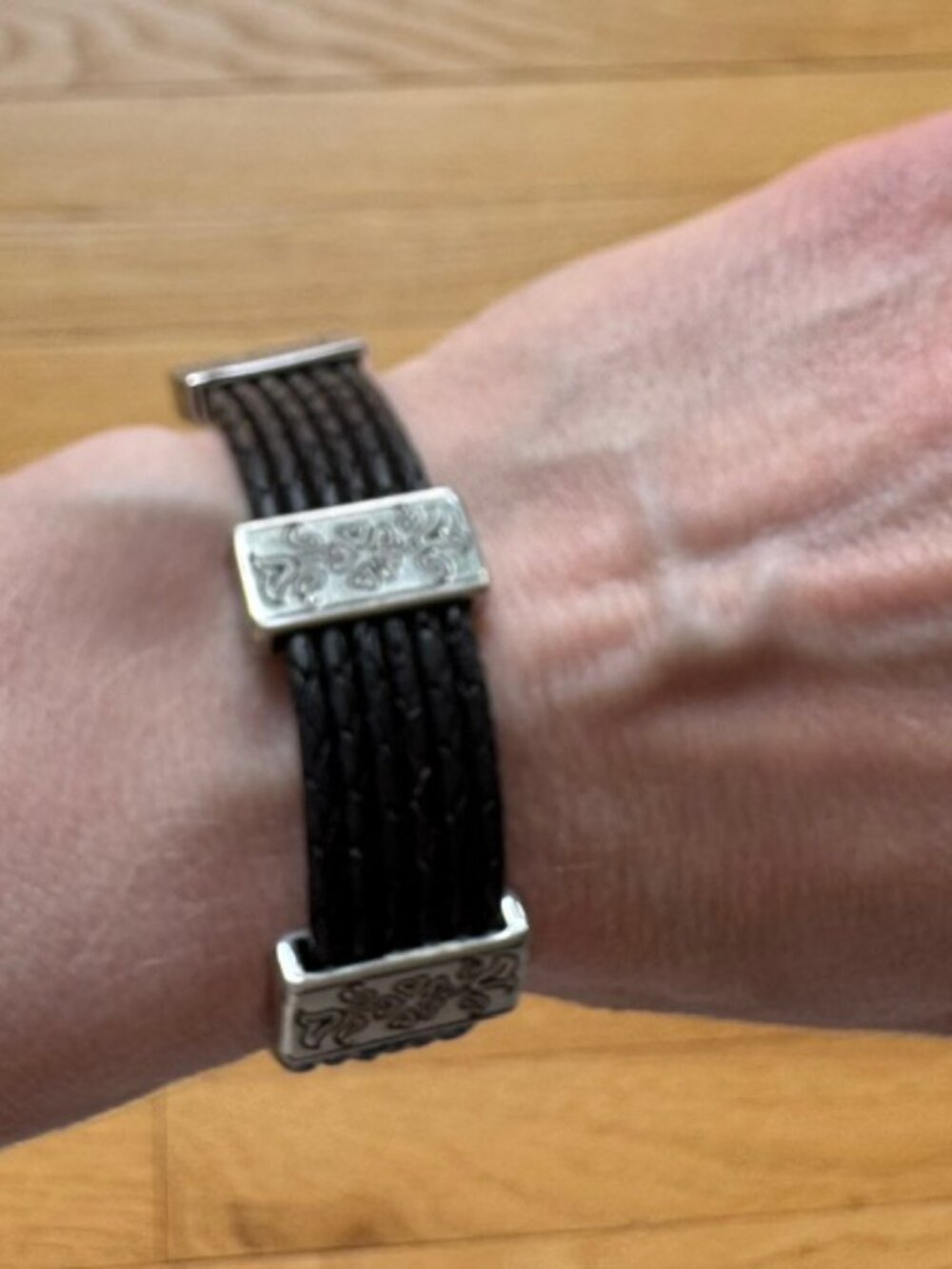 Black leather and silver accent bracelet